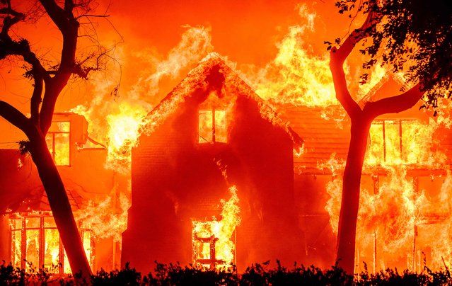 A home is engulfed in flames during the Eaton fire in the Altadena area of Los Angeles County, California on January 8, 2025. (Photo by Josh Edelson/AFP Photo)