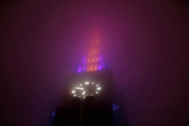 A clock tower building is seen through a foggy rainfall as Typhoon Lan approaches Japan's mainland, in Tokyo, Japan October 21, 2017. (Photo by Issei Kato/Reuters)