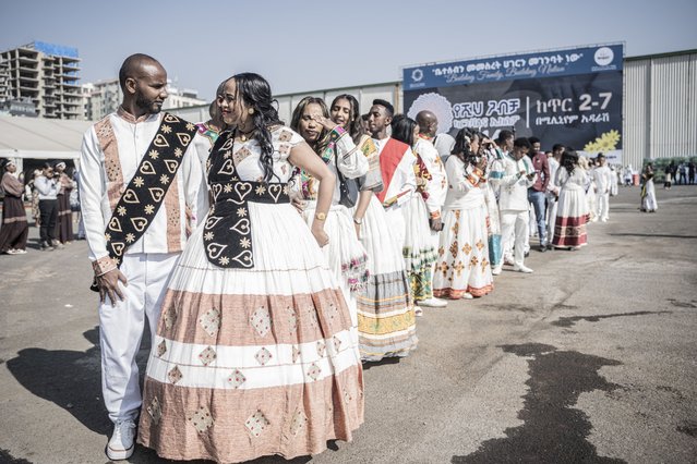 Couples dressed in a traditional attire line up during a mass wedding called “Yeshih Gabicha” in Addis Ababa, Ethiopia on January 14, 2024. Hundreds of couples gathered in Ethiopia's capital on January 14, 2024 to take part in a traditional mass wedding ceremony, the first such event in a decade, according to the organisers and participants. Dressed in traditional white clothes, the couples sang and danced in the streets outside the wedding venue before the ceremony began, bringing together Ethiopians from around the country. (Photo by Amanuel Sileshi/AFP Photo)