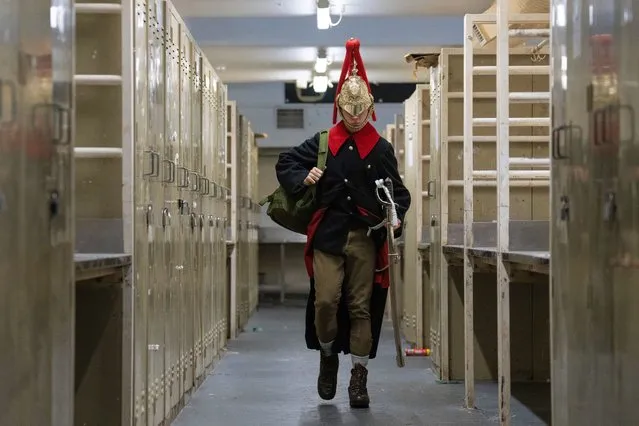 A Household Cavalry soldier walks out of the cleaning room in dress uniform at Hyde Park Barracks on November 21, 2022 in London, England. The soldiers and horses here will participate in several ceremonial events during this week's state visit by the president of South Africa, including a guard of honour, gun salutes and a parade along the Mall. (Photo by Carl Court/Getty Images)