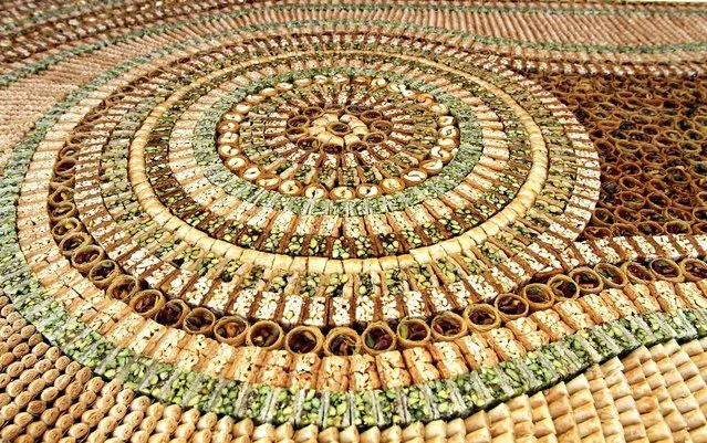 A mosaic of traditional Arabic sweets, measuring 112 meters long, entered the Guinness Book of World Records as the biggest of its kind on July 14, 2010 in Damascus. (Photo by Louai Beshara/AFP Photo)