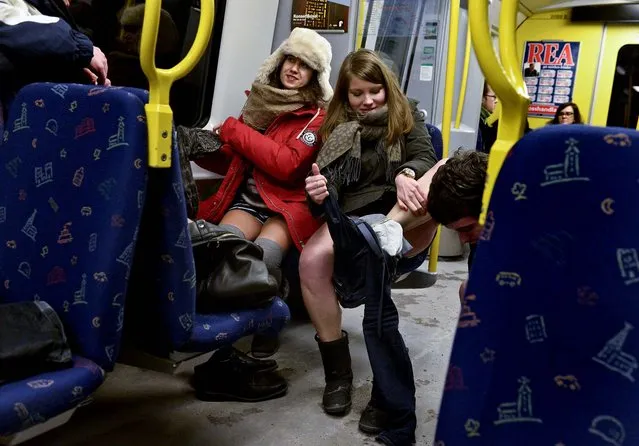 Participants shed their clothes to take part in the annual “No Pants Subway Ride” in Stockholm. The yearly prank, organized by New York City based prank collective “Improv Everywhere” was started in 2002, asking participants to ride subway lines trouser free and act straight faced about it. (Photo by Jan Erik Henriksson/Associated Press)