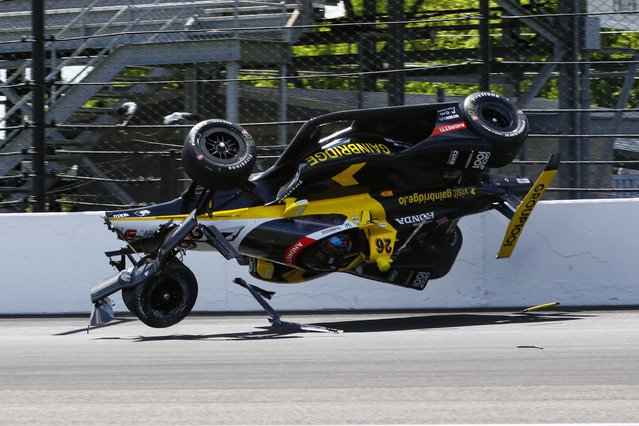 The car driven by Colton Herta goes airborne after hitting the wall in the first turn during a qualification attempt for the Indianapolis 500 auto race at Indianapolis Motor Speedway in Indianapolis, Saturday, May 17, 2025. (Photo by Kirk DeBrunner/AP Photo)