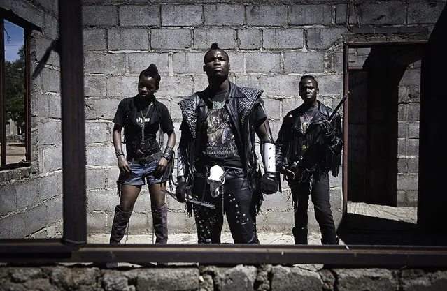 “Edith, Hellrider, and Dadmonster pose for a photograph. In Botswana, heavy metal music has landed. Metal groups are now performing in nightclubs, concerts, festivals. The ranks of their fans have expanded dramatically. These fans wear black leather pants and jackets, studded belts, boots and cowboy hats. (Photo and comment by Daniele Tamagni, Italy/2013 Sony World Photography Awards