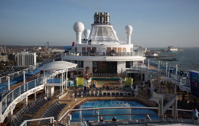 People sit and enjoy the facilites on the top deck onboard the cruise ship Quantum of the Seas which is currently docked at Southampton on October 31, 2014 in Southampton, England. (Photo by Matt Cardy/Getty Images)