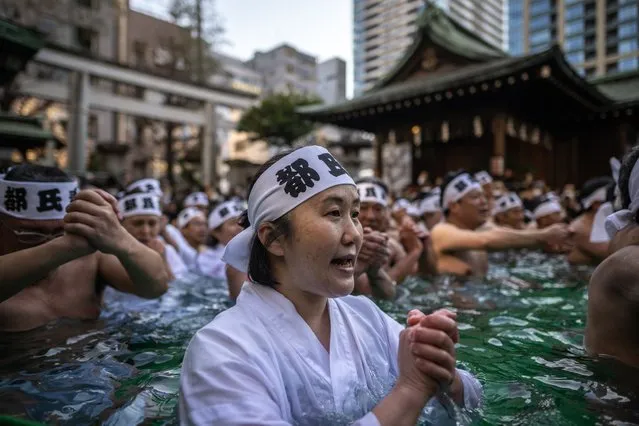Shinto believers of the Teppozu Inari Shrine take a bath in cold water to purify their souls and bodies during a New Year ritual in Tokyo on January 8, 2023. (Photo by Philip Fong/AFP Photo)