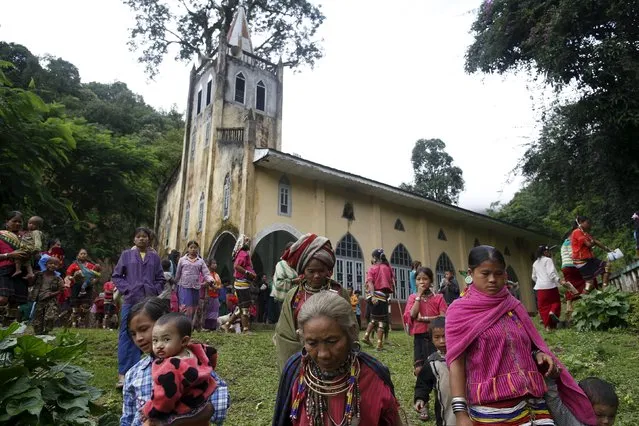 Ethnic Kayaw people walk out after a mass at the catholic church at Htaykho village in the Kayah state, Myanmar September 13, 2015. (Photo by Soe Zeya Tun/Reuters)
