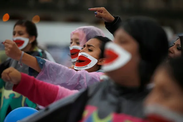 Pro-abortion activists wearing masks over their mouths shout slogans during a demonstration to demand the decriminalization of abortion in Mexico City, Mexico September 28, 2016. (Photo by Carlos Jasso/Reuters)