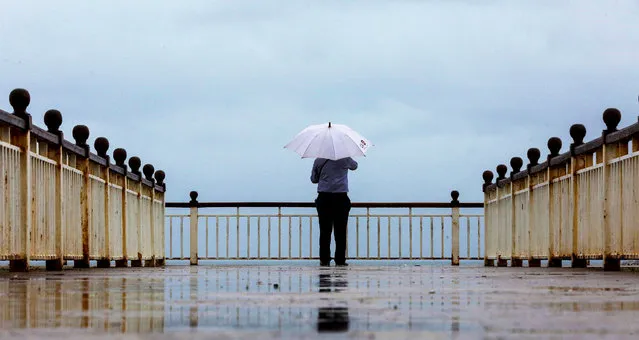 A person looking over the seafront during a spell of  rain in Colombo, Sri Lanka, 02 September 2020. The Sri Lankan capital will experience heavy showers due to the low-level atmospheric disturbances around the island, according to the local meteorological department. (Photo by Chamila Karunarathne/EPA/EFE/Rex Features/Shutterstock)