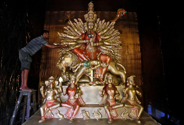 An artisan places an artificial arrow on an idol of Hindu goddess Durga at a pandal, a temporary platform, during preparations for the upcoming Durga Puja festival in Kolkata, India September 28, 2016. (Photo by Rupak De Chowdhuri/Reuters)