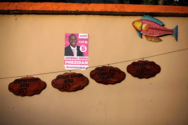 An electoral poster of presidential candidate Jovenel Moise plastered on a wall at a handcraft store in a street of Port-au-Prince, Haiti, September 21, 2016. (Photo by Andres Martinez Casares/Reuters)