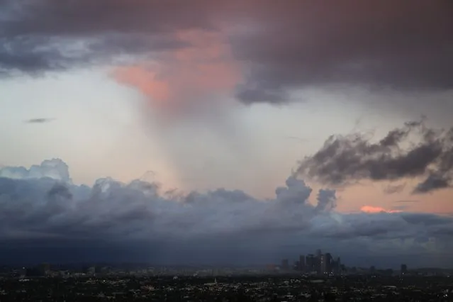 The downtown Los Angeles skyline is surrounded by clouds during heavy rains in Los Angeles, California December 12, 2014. (Photo by Patrick T. Fallon/Reuters)