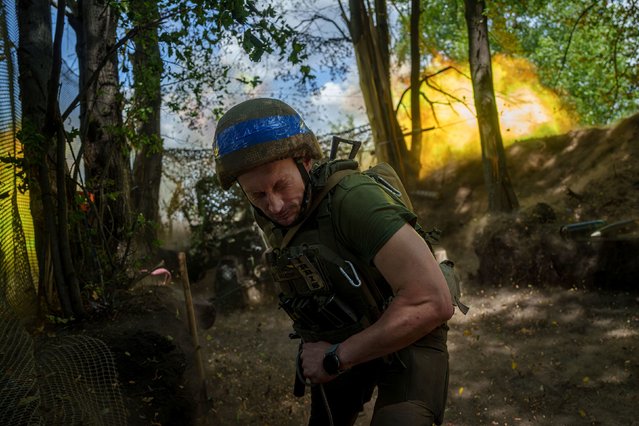 A Ukrainian national guard serviceman aka “Master” of Khartia brigade fires by a D-20 cannon towards Russian positions at the frontline near Kharkiv, Ukraine, Monday, June 10, 2024. (Photo by Evgeniy Maloletka/AP Photo)