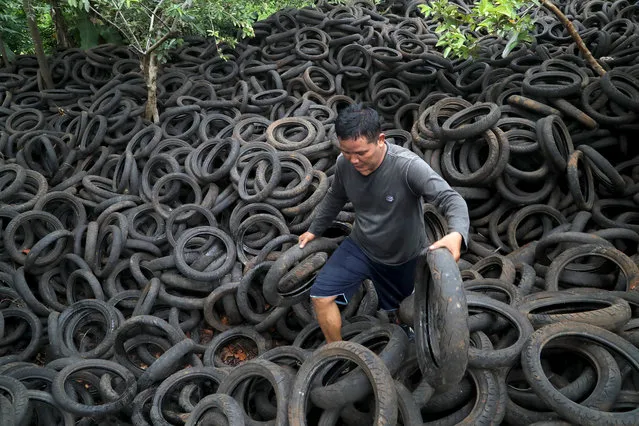 A person sorts used motorbike tires in Depok, West Java, Indonesia, 17 November 2020. According to media reports, Indonesia has fallen into a recession for the first time in 22 years, due to effects of the coronavirus pandemic. According to the central statistics agency (BPS), the country's economy contracted by 3.49 percent in the third quarter of 2020. (Photo by Bagus Indahono/EPA/EFE)