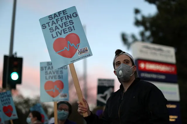 People attend a protest for nurses demanding more PPE, coronavirus testing, and staff, as the outbreak of the coronavirus disease (COVID-19) continues, in West Hills, Los Angeles, California, U.S., November 30, 2020. (Photo by Lucy Nicholson/Reuters)