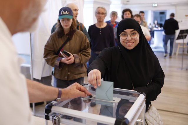 A woman votes in Strasbourg, eastern France, Sunday, June 30, 2024. France is holding the first round of an early parliamentary election on Sunday that could bring the country's first far-right government since Nazi occupation during World War II. The second round is on July 7, and the outcome of the vote remains highly uncertain. (Photo by Jean-Francois Badias/AP Photo)