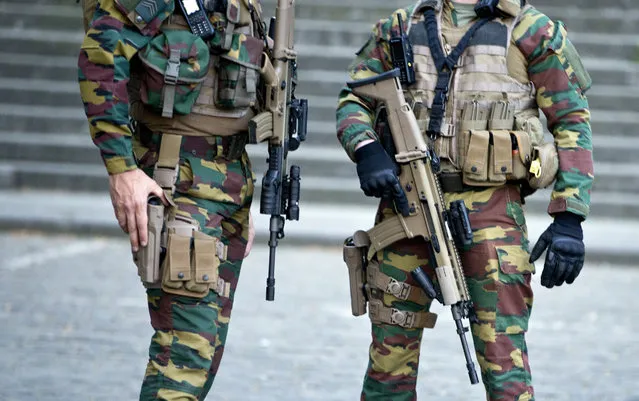Belgian Army soldiers patrol outside the Brussels justice palace during the trial of Saleh Abdeslam and Soufiane Ayari in Brussels, Monday, April 23, 2018. The sole surviving suspect in the 2015 Paris extremist attacks who was once Europe's most wanted fugitive will hear his judgment in an attempted murder case on Monday. Salah Abdeslam's verdict will be heard for his involvement in a March 15, 2016, police shootout, four months after the Paris attacks that killed 130. (Photo by Virginia Mayo/AP Photo)