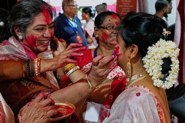Hindu women smear vermillion on each other on the final day of the Durga Puja festival in Mumbai, India, Thursday, October 2, 2025. (Photo by Rajanish Kakade/AP Photo)