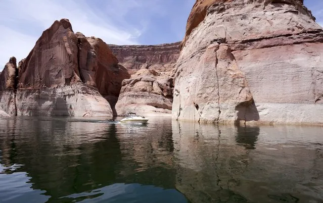A power boat cruises though Cathedral Canyon, part of Lake Powell, near Page, Arizona, May 27, 2015. (Photo by Rick Wilking/Reuters)