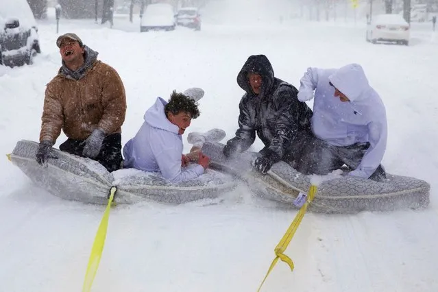 Brothers of the Phi Gamma Delta Fraternity pull their friends on mattresses along the street in front of the UNL Union during a winter storm in downtown Lincoln, Neb. on Monday, January 25, 2021. (Photo by Kenneth Ferriera/Lincoln Journal Star via AP Photo)