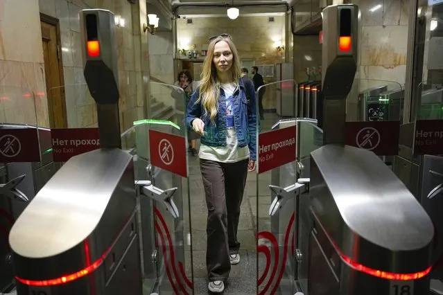 Yekaterina Maksimova enters a Moscow subway station in Moscow, Russia, Monday, May 22, 2023. The journalist and activist has been detained five times in the past year, thanks to the system's pervasive security cameras with facial recognition. She says police would tell her the cameras “reacted” to her – although they often seemed not to understand why, and would let her go after a few hours. (Photo by Alexander Zemlianichenko/AP Photo)