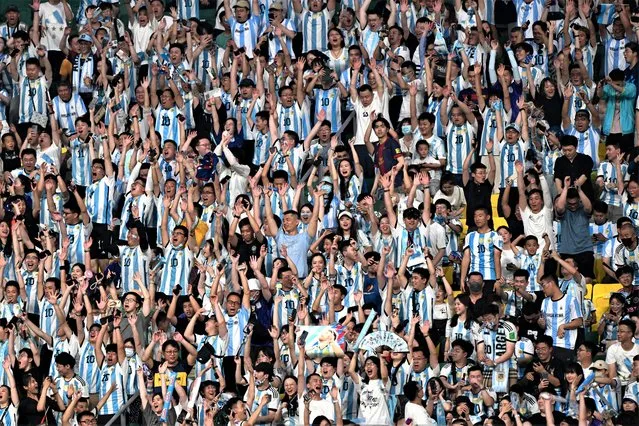 Fans wearing Argentina's football jerseys cheer during a friendly match between Australia and Argentina at the Workers' Stadium in Beijing on June 15, 2023. (Photo by Pedro Pardo/AFP Photo)