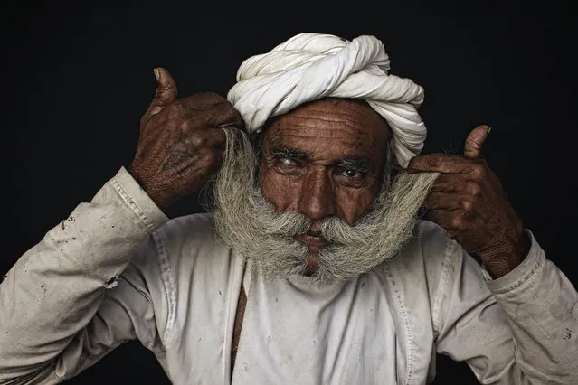 “A big moustache”. Rabari elder showing off his big moustache, the bigger the moustache the more status. Rabari men wear red turbans and white clothes. Sometimes they might use white turbans also. They wear silver bracelets and golden earrings The men like smoking tobacco in Chillums (small Pipe). They also sit together and drink Opium mixed with water, during festivals and ceremonies, after offering it to Gods. Custom is to offer it to each other as well. Location: Image taken close to Mt. Abu, South Rajahstan, India. (Photo and caption by Ingetje Tadros/National Geographic Traveler Photo Contest)