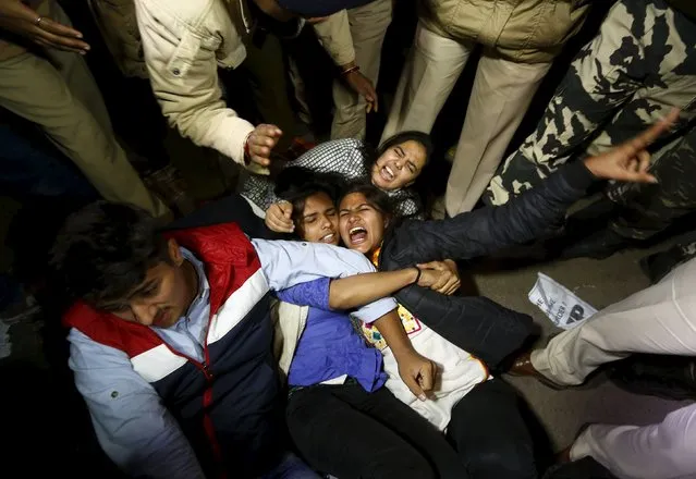 Police detain demonstrators during a protest against the release of a juvenile rape convict, in New Delhi, India, December 20, 2015. The youngest of six people convicted of the 2012 gang rape of a woman, in a case that shocked India, was freed on Sunday, a lawyer said, after a court refused to extend his three-year sentence. The case turned a global spotlight on the treatment of women in India, where police say a rape is reported every 20 minutes, and the sentence sparked debate over whether the country is too soft on young offenders. (Photo by Adnan Abidi/Reuters)