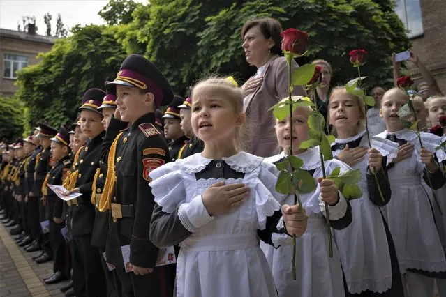 Young cadets sing the national anthem during a graduation ceremony in a cadet lyceum in Kyiv, Ukraine, Tuesday, June 13, 2023. (Photo by Efrem Lukatsky/AP Photo)