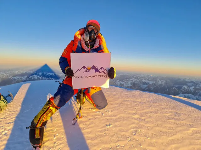 A handout photo made available by Seven Summit Treks shows Nepalese mountaineer Sona Sherpa holding the banner of Seven Summit Treks on the top of Mt. K2, Pakistan, 16 January 2021. A team of 10 Nepali mountaineers made the first successful winter ascent of Mt. K2, reaching the summit on 16 January 2021. With a height of 8,611 meters, Mt. K2 is the second highest in the world. (Photo by Seven Summit Treks/EPA/EFE)