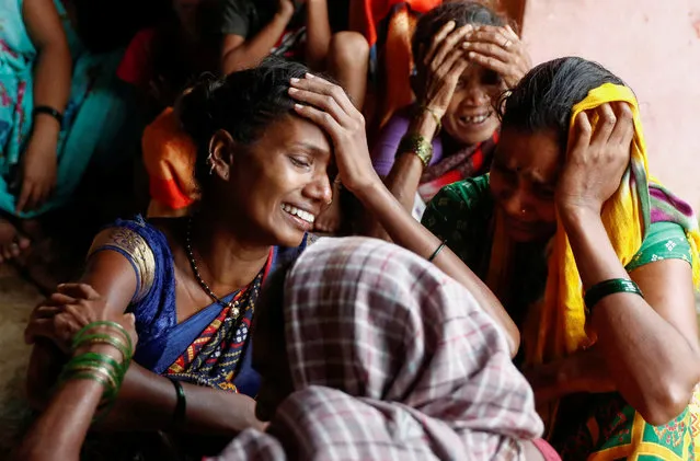 Women mourn the death of their relatives, after a landslide hit a village in Raigad, in the western Indian state of Maharashtra, India on July 20, 2023. (Photo by Francis Mascarenhas/Reuters)