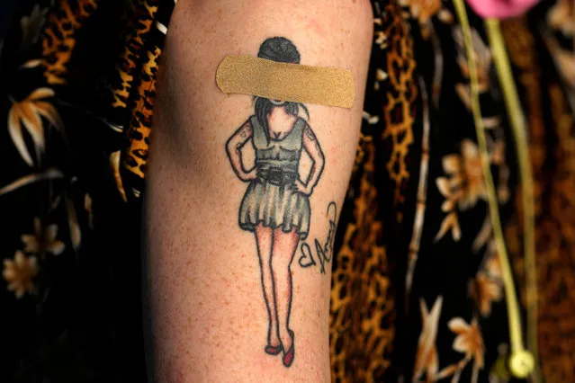 A tattoo of British singer Amy Winehouse is covered with a bandaid, on the arm of a member of the public after they were inoculated with the a dose of the Johnson and Johnson COVID-19 vaccine, during a “Take The Shot – Get a Beer” event in Washington DC, USA, 06 May 2021. The event encouraged members of the public to get vaccinated by offering a free beer after vaccination. (Photo by Will Oliver/EPA/EFE)