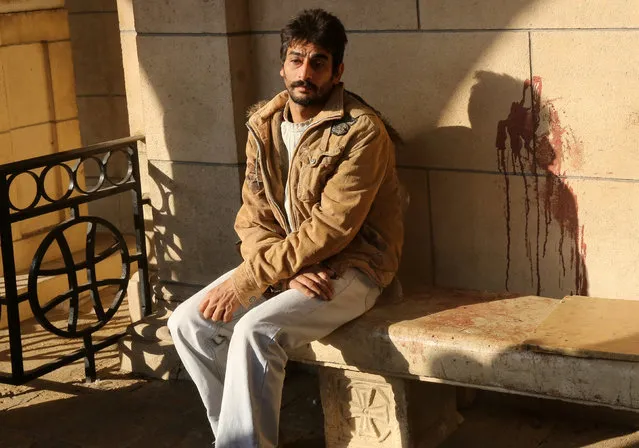 An Egyptian Christian sits on a bench near a blood stain on a wall at the scene following a bombing inside Cairo's Coptic cathedral in Egypt December 11, 2016. (Photo by Mohamed Abd El Ghany/Reuters)