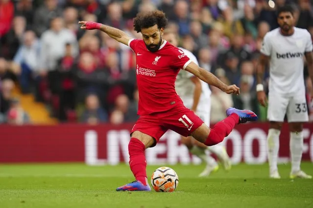 Liverpool's Mohamed Salah scores his side's opening goal from a penalty kick during the English Premier League soccer match between Liverpool and West Ham at the Anfield stadium in Liverpool, England, Sunday, September 24, 2023. (Photo by Jon Super/AP Photo)