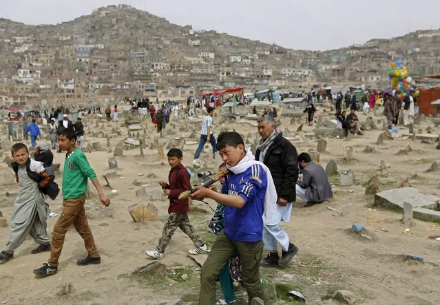 A boy plays with toy gun during celebrations for Afghan New Year (Newroz) in Kabul March 21, 2015. (Photo by Mohammad Ismail/Reuters)