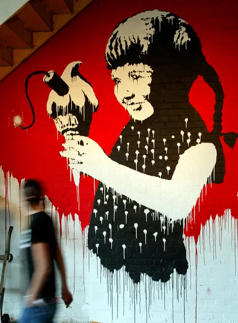 A Banksy painting of a young girl with a stick of dynamite in her ice cream on display at a London exhibtion in 2003. (Photo by Reuters/Stringer)