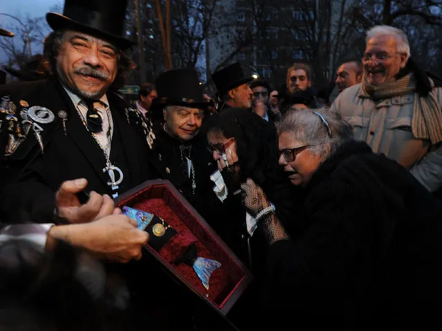 Mourners weep for the dead sardine during the “Burial of the Sardine” procession on February 10, 2016 in Madrid, Spain. The Sardine procession is a centuries-old Spanish tradition made famous by a painting by Spanish artist Francisco de Goya called “El Entierro de La Sardina”. The mourners hold a mock funeral procession mourning the end of Carnival  through the heart of old “Castizo” Madrid visiting and enjoying the wines and tapas of local taverns. (Photo by Denis Doyle/Getty Images)