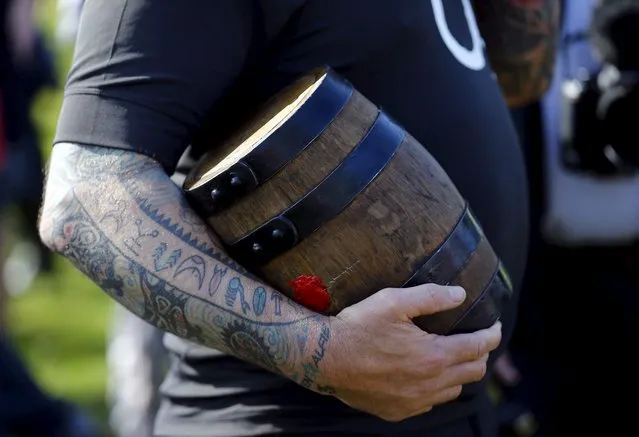 A player holds a bottle before the bottle-kicking game in Hallaton, central England April 6, 2015. (Photo by Darren Staples/Reuters)