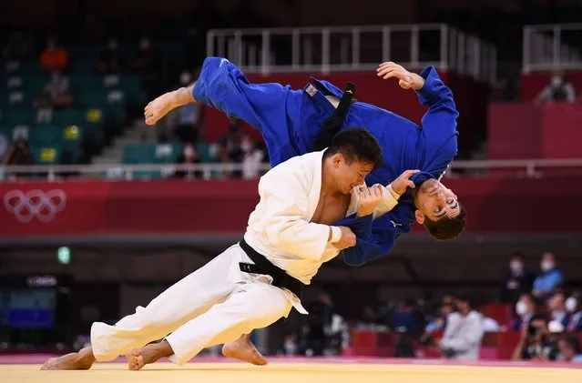 Shoichiro Mukai, of Japan, scores a point against Eduard Trippel, of Germany, during a mixed team judo quarterfinal at Nippon Budokan in Tokyo, Japan on July 31, 2021. (Photo by Annegret Hilse/Reuters)