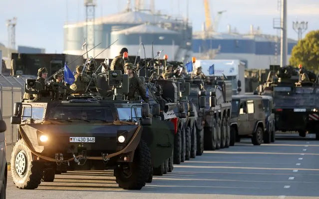 Members of the German Bundeswehr 41st Mechanized Infantry Brigade Forward Command Element, 1st Panzer Division are pictured upon arrival in the port of Klaipeda, Lithuania on September 4, 2022. The first soldiers of the German brigade arrived in Lithuania on September 4, 2022, as NATO pledged to strengthen its eastern flank amid the Russian invasion of Ukraine. (Photo by Petras Malukas/AFP Photo)
