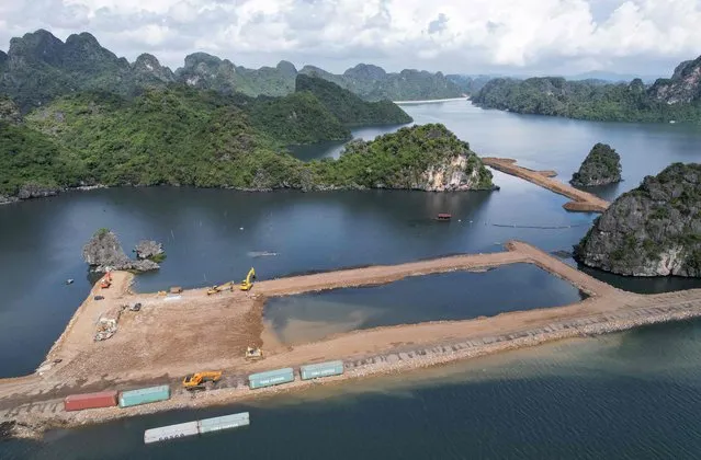 This aerial photo taken on November 4, 2023 shows the construction site of a residential and hotel complex near Ha Long Bay in Vietnam's Quang Ninh province. A huge residential complex being built on the borders of Vietnam's Ha Long Bay prompted a public outcry in the Southeast Asian country on November 6, 2023, as concerns mount over human impacts that have degraded the UNESCO World Heritage Site. (Photo by Hoang Duong/AFP Photo)