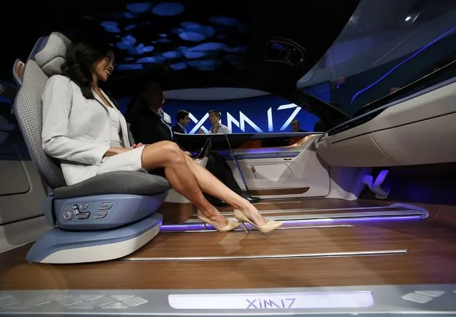 People try out the XIM 17 vehicle interior concept unveiled by Yanfeng Automotive Interiors during the North American International Auto Show in Detroit, Michigan, U.S., January 10, 2017. (Photo by Brendan McDermid/Reuters)