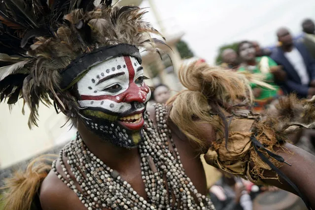 A traditional dancer performs as supporters of Congolese President elect Felix Tshisekedi gather at the Palais de la Nation for his inauguration in Kinshasa, Democratic Republic of the Congo, Thursday January 24, 2019. Tshisekedi won an election that raised numerous concerns about voting irregularities amongst observers as the country chose a successor to longtime President Joseph Kabila. (Photo by Jerome Delay/AP Photo)