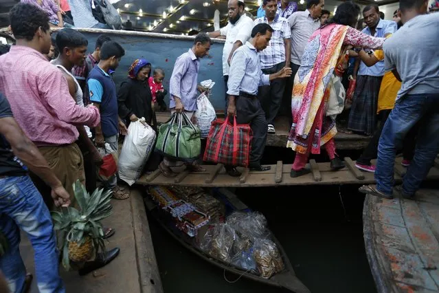Bangladeshi Muslims board a ferry to travel to their hometowns for Eid al-Adha festival in Dhaka, Bangladesh, Friday, September 9, 2016. Muslims around the world celebrate Eid al-Adha, or the Feast of the Sacrifice, to commemorate the prophet Ibrahim's faith in being willing to sacrifice his son. (Photo by A.M. Ahad/AP Photo)
