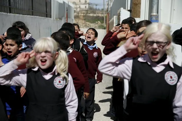 Blind and visually impaired Palestinian students take part in an exercise at a school where they are taught English through song and music, at a school in the West Bank city of Hebron March 2, 2016. (Photo by Ammar Awad/Reuters)