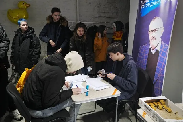 People sign petitions in St. Petersburg, Russia, on Tuesday, January 23, 2024, for Boris Nadezhdin, a liberal Russian politician who is seeking to run in the March 17 presidential election. (Photo by Dmitri Lovetsky/AP Photo)