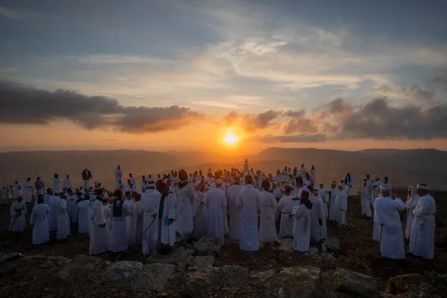 Members of the ancient Samaritan community attend the pilgrimage for the holiday of the Tabernacles or Sukkot at the religion's holiest site on the top of Mount Gerizim, near the West Bank town of Nablus, early Wednesday, October 20, 2021. (Photo by ajdi Mohammed/AP Photo/)
