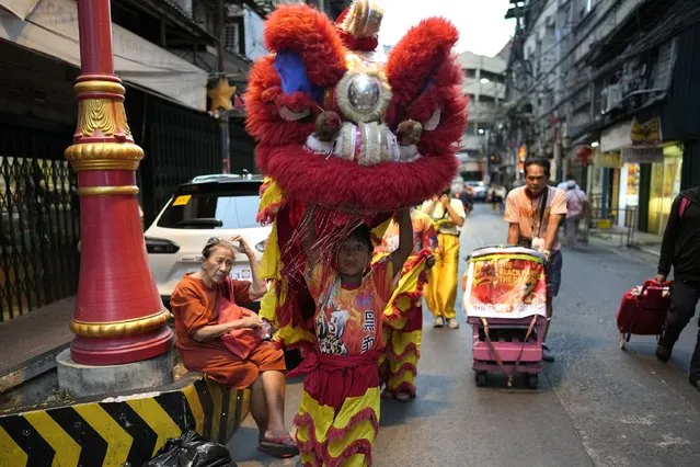 A lion performer walks at Binondo district, said to be the oldest Chinatown in the world, in Manila, Philippines on Tuesday, FFebruary 6, 2024. (Photo by Aaron Favila/AP Photo)