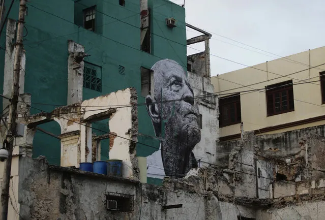 A creation, part of the “Wrinkles Of The City” project, by Cuban-American artist Jose Parla and JR is seen on a wall in Havana May 10, 2012. (Photo by Desmond Boylan/Reuters)