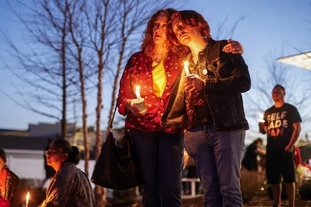 Dawn Markle and her son Evan Markle of Adair participate in a community candlelight vigil for Nex Benedict, an Oklahoma teenager who died the day after a fight in a high school bathroom in which the nonbinary student said they were a target of bullying, Sunday, February 25, 2024, in Owasso, Okla. (Photo by Mike Simons/Tulsa World via AP Photo)